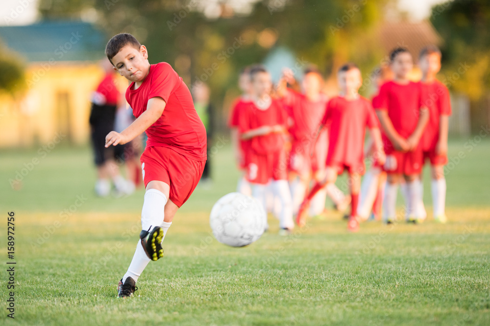Kids soccer football - children players match on soccer field Kids soccer football - children players match on soccer field