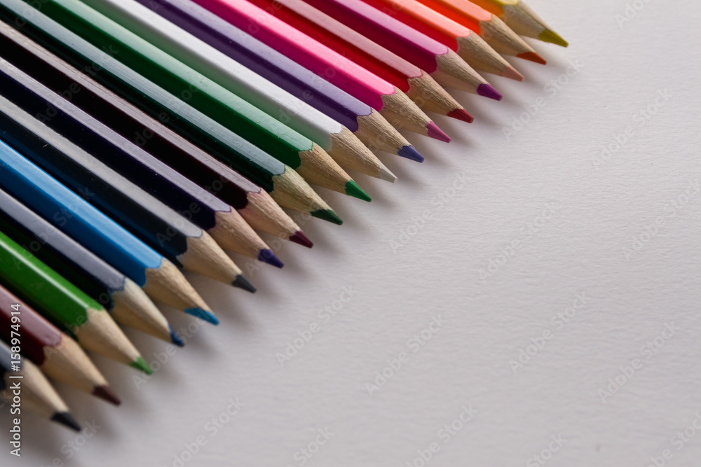 Multicolored pencils and pencil shaves on white background. Copy space Multicolored pencils and pencil shaves on white background. Copy space