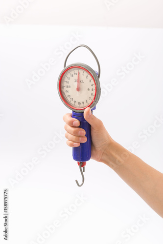 Female hands on a white background with a steelyard photo