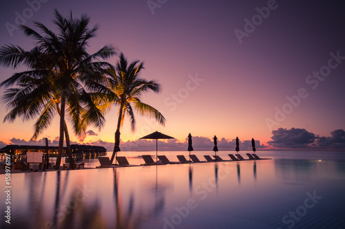Luxury poolside on the beach with sunset colors. Amazing luxury summer background