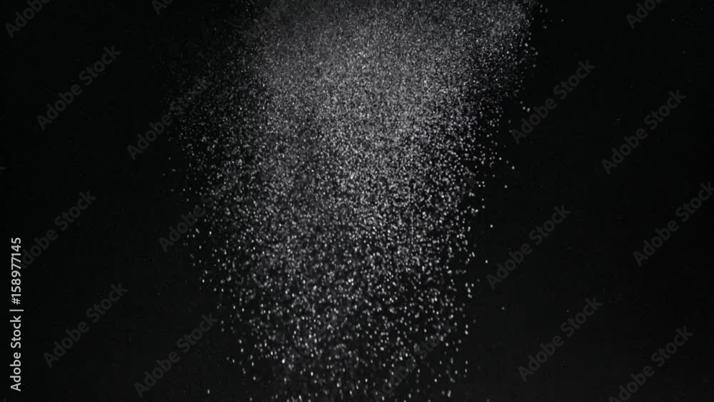 Burst of particles coming in from top of frame studio shot 4K