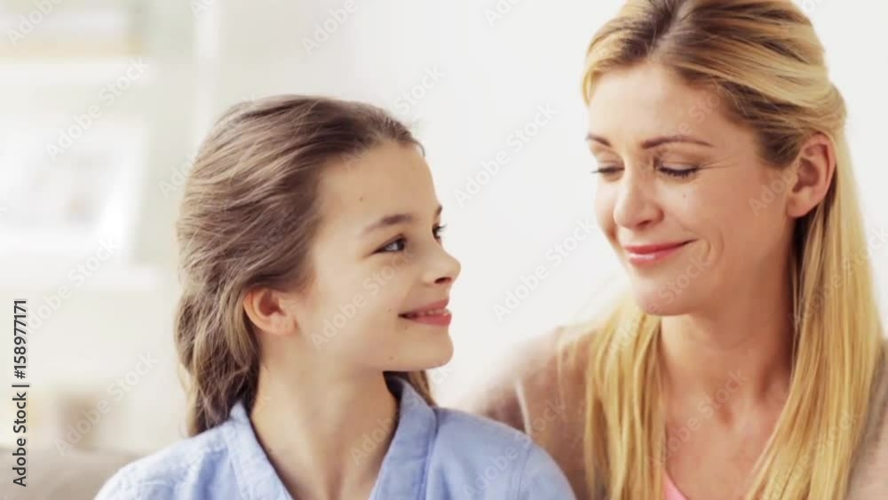 mother and girl turning to each other at home mother and girl turning to each other at home