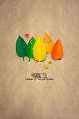 Happy Thanksgiving day / Creative thanksgiving day concept photo of leaves made of paper on brown background.
