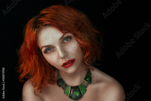 Fototapeta Naklejka Na Ścianę i Meble -  Portrait of a beautiful red-haired woman with jewelry beaded necklaces