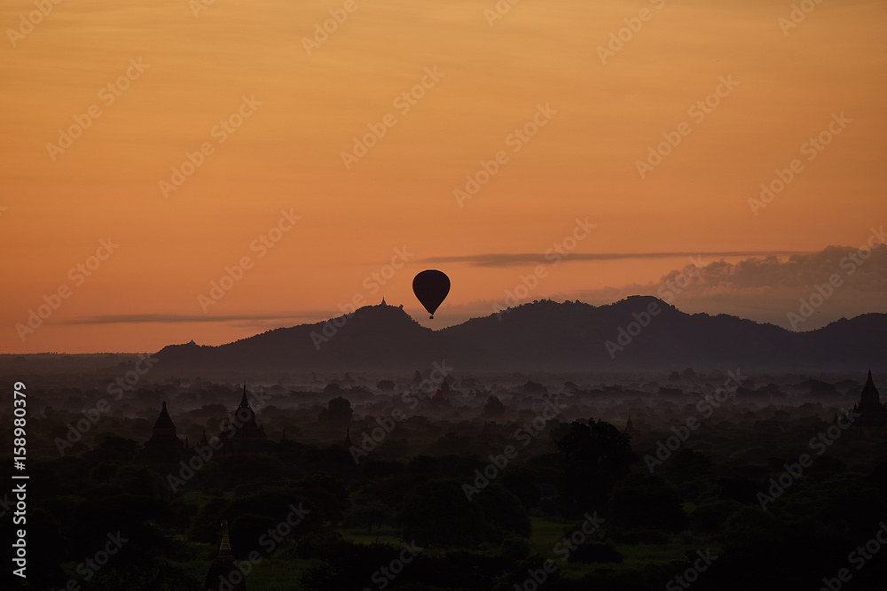 Hot air balloons hovering over pagodas in the ancient city of Bagan in myanmar