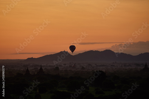 Hot air balloons hovering over pagodas in the ancient city of Bagan in myanmar