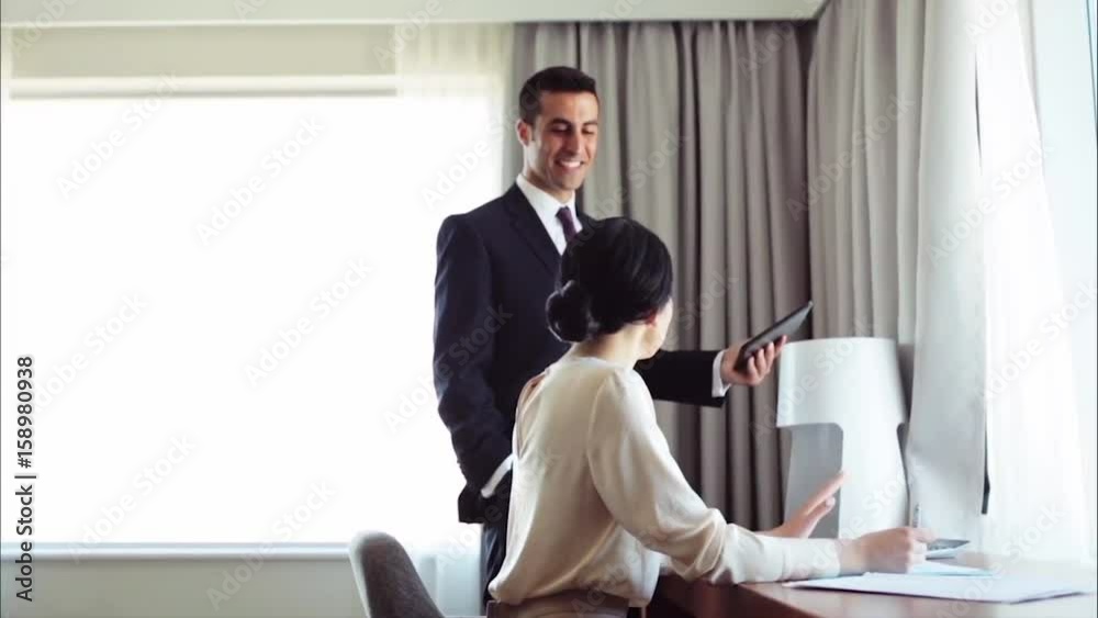 business team with papers and tablet pc at hotel business team with papers and tablet pc at hotel