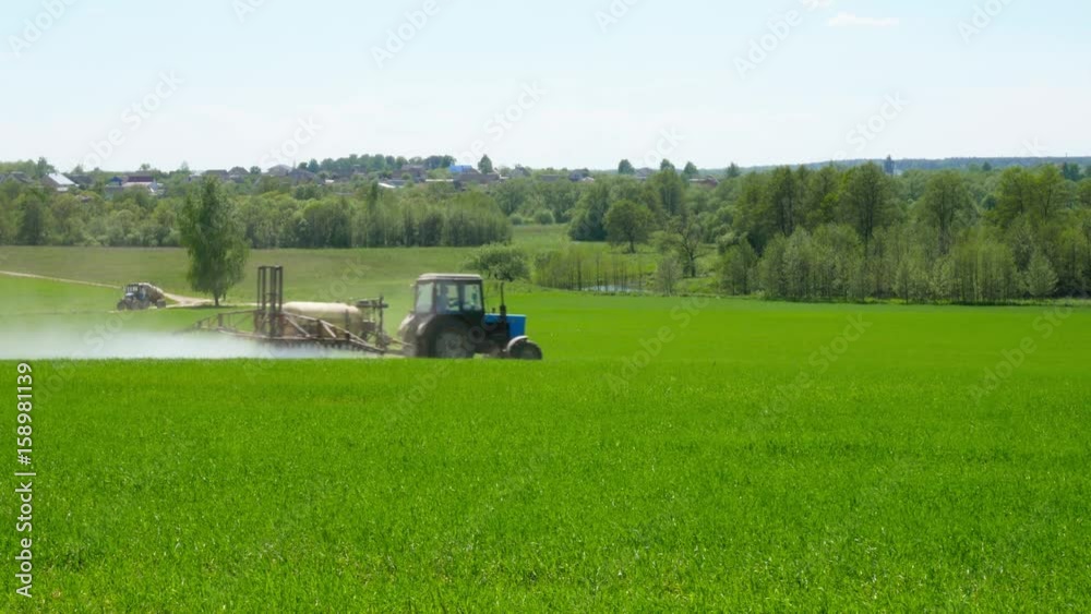 Agricultural machinery is working in the field. Irrigation of fields.