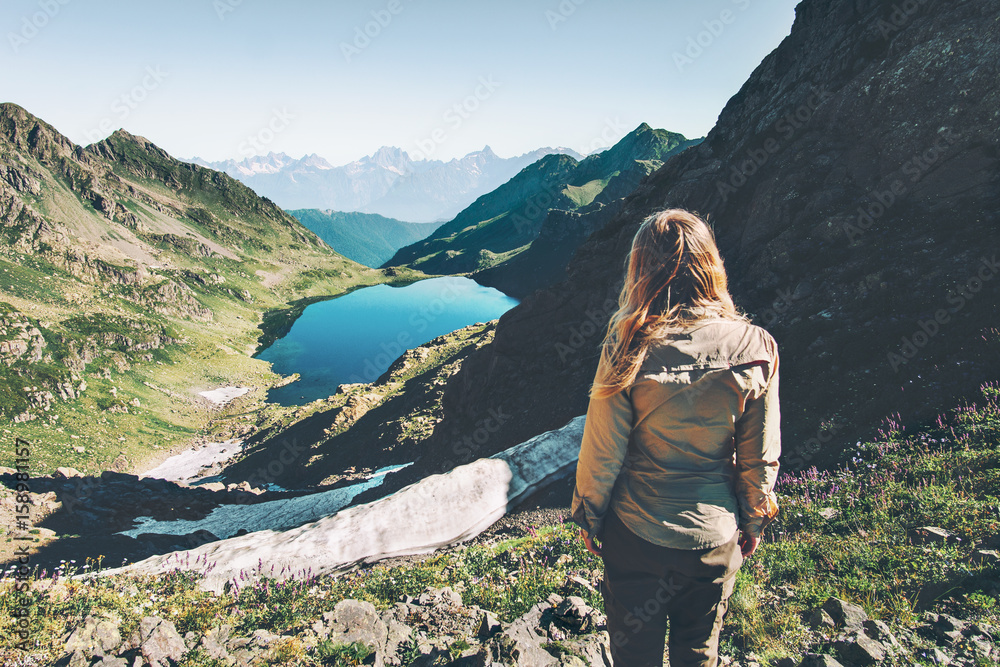 Woman traveler walking at lake in mountains Travel Lifestyle adventure concept summer vacations outdoor exploring landscapes