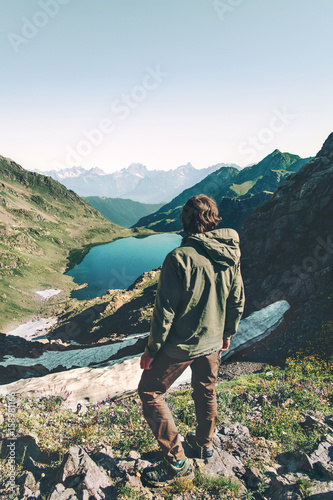 Billede på lærred Man explorer wander lake in mountains aerial view Travel Lifestyle adventure con