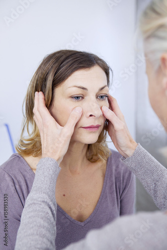 Doctor examining a patient's sinuses