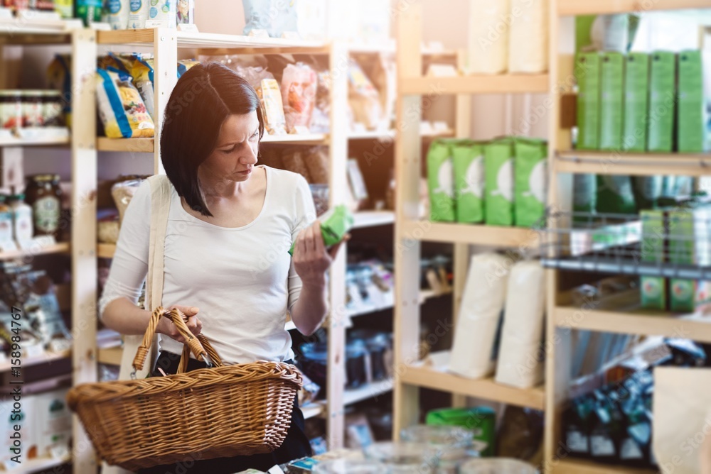 Woman reading product information on label