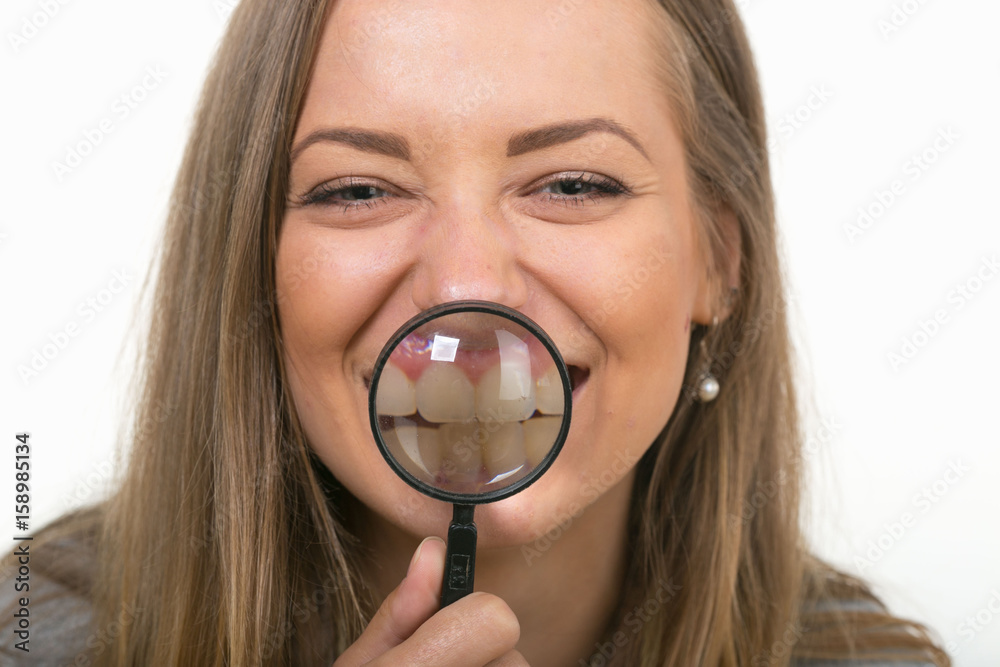 Beautiful girl on a white background with a magnifying glass Beautiful girl on a white background with a magnifying glass