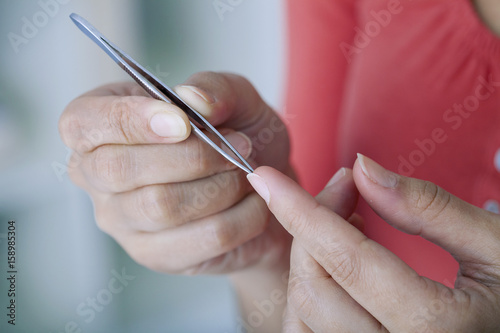 Woman removing a splinter