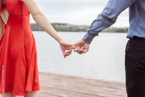 Filtered image, couple holding hands in wedding outdoor theme © romanets_v