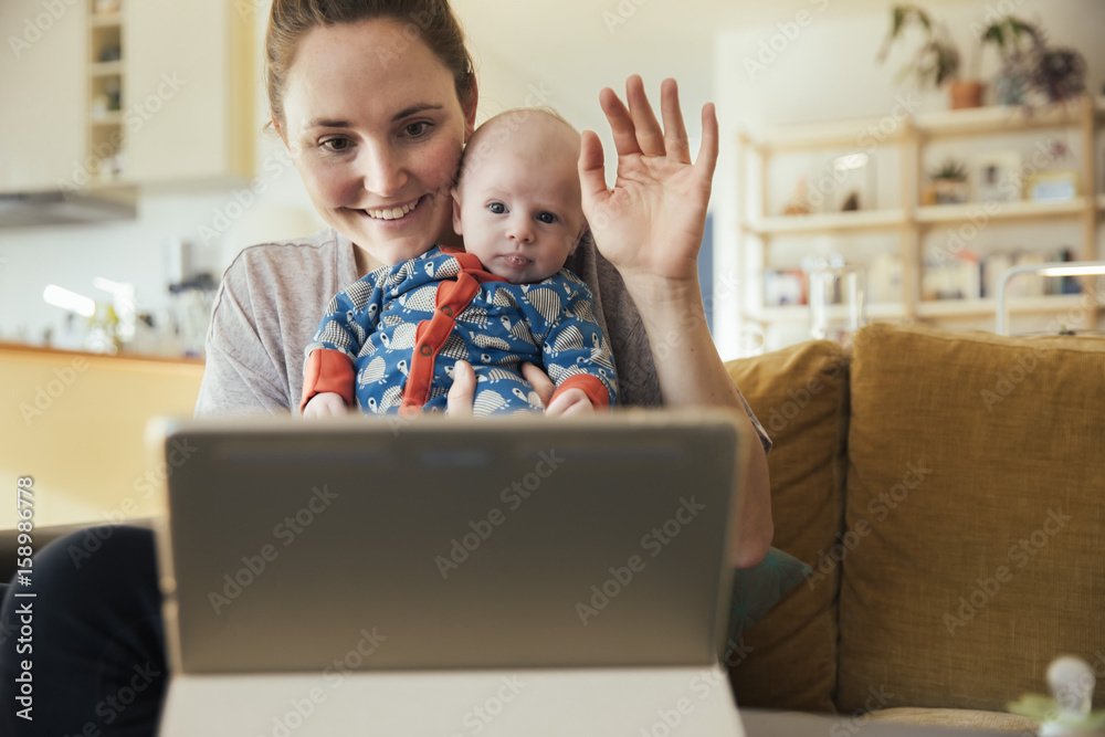 Mother and newborn baby taking a video call at home Mother and newborn baby taking a video call at home