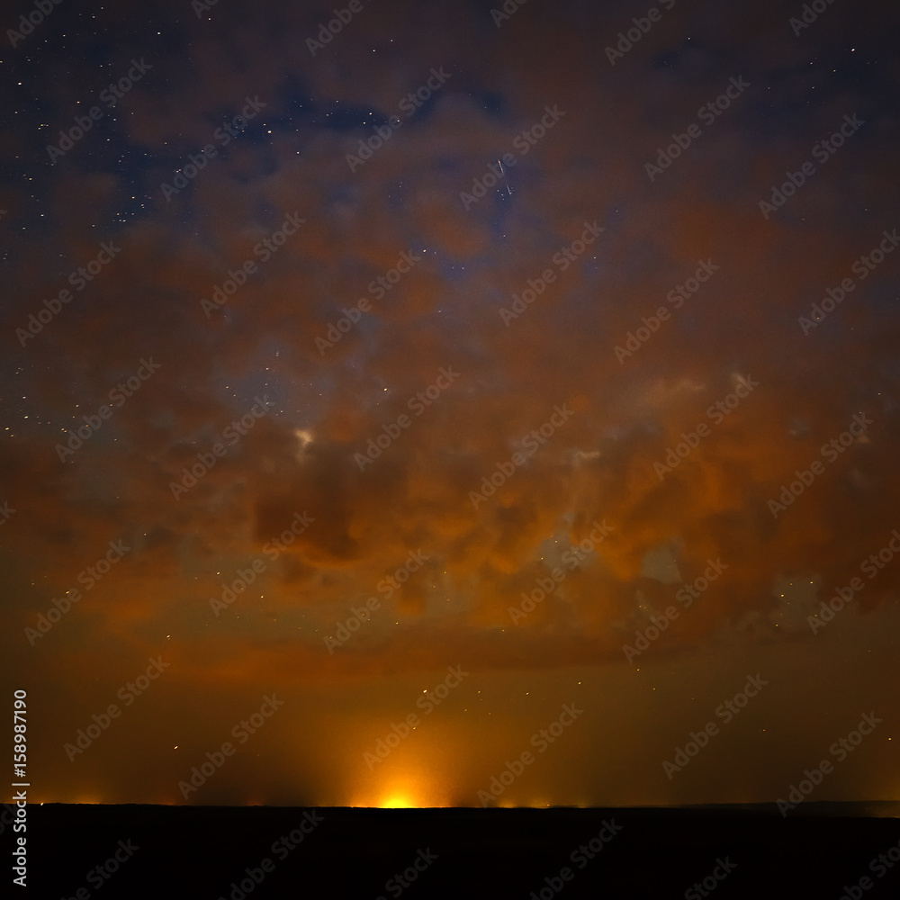 Clouds at night against the background of bright stars in the sky after sunset. Clouds at night against the background of bright stars in the sky after sunset.