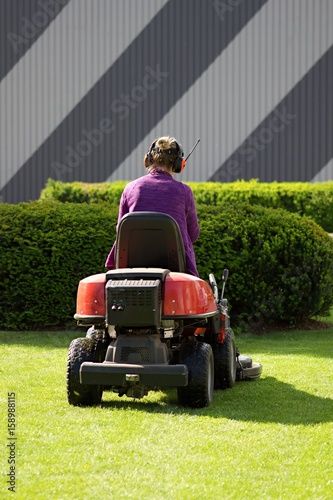 Woman with garden lawn mower