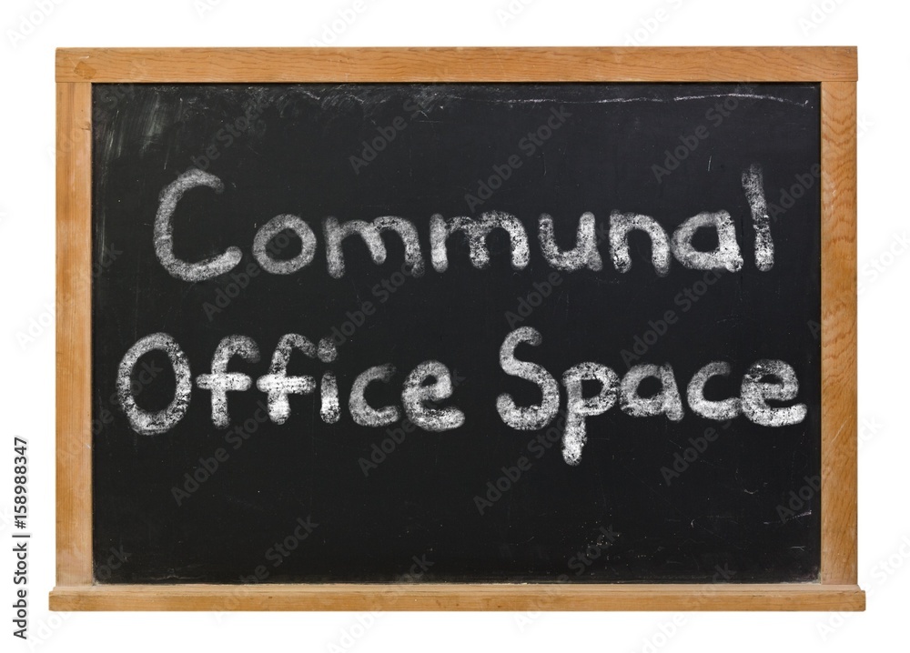 Fototapeta premium Communal Office Space written in white chalk on a black chalkboard isolated on white