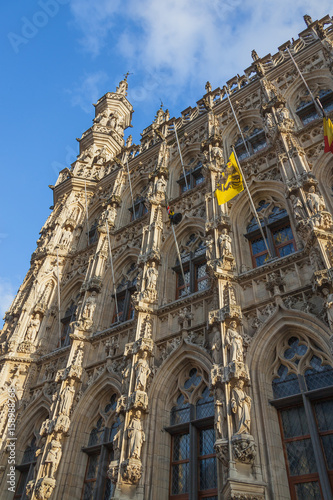 Gothic facade of the Town Hall of Leuven on blue sky background, Belgium