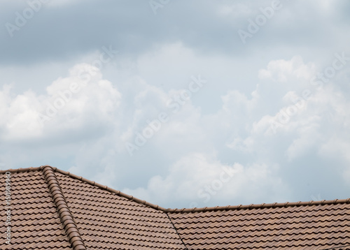 brown peaked roof. a roof top with red tiles.