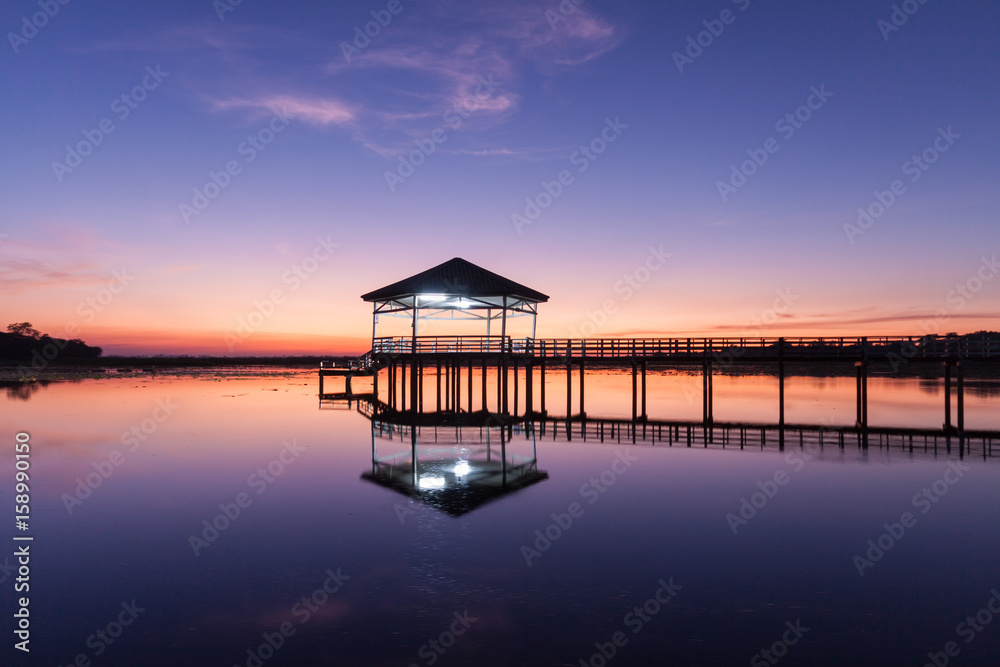 Sunset, Twilight at the reservoir with pavilion,Silhouette.(Bueng Si Fai Phichit.) Sunset, Twilight at the reservoir with pavilion,Silhouette.(Bueng Si Fai Phichit.)