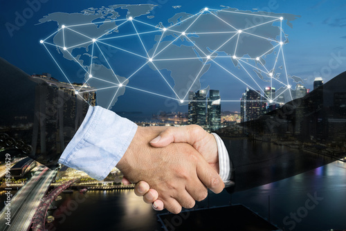 Deal or agreement business concept, handshake double exposure, cooperation or partnership business with global connection partnership map. photo