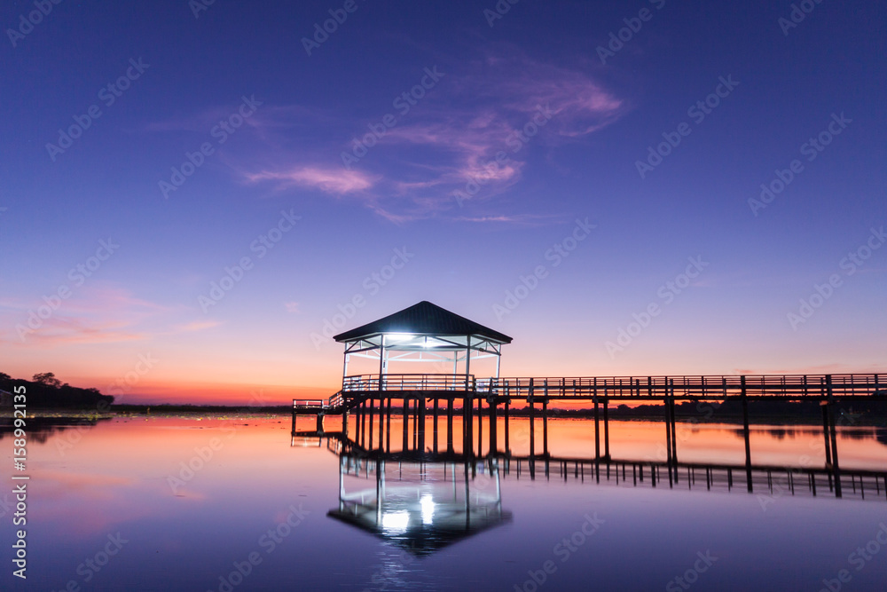 Sunset, Twilight at the reservoir with pavilion,Silhouette.(Bueng Si Fai Phichit.) Sunset, Twilight at the reservoir with pavilion,Silhouette.(Bueng Si Fai Phichit.)