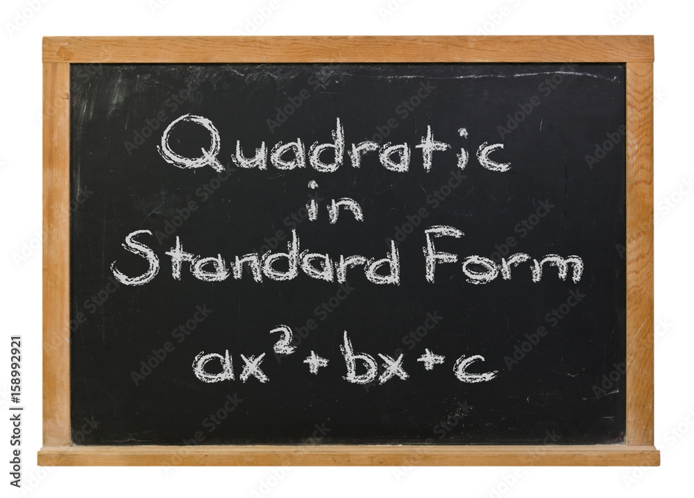 Quadratic equation in standard form written in white chalk on a black chalkboard isolated on white Quadratic equation in standard form written in white chalk on a black chalkboard isolated on white