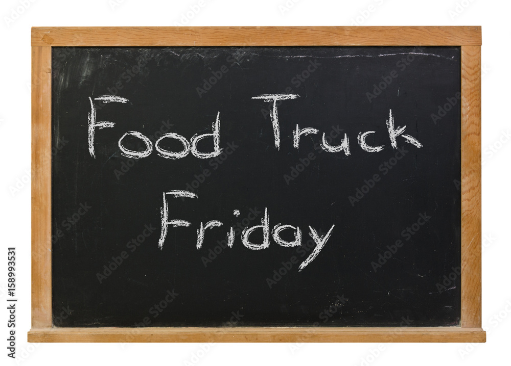 Food Truck Friday written in white chalk on a black chalkboard isolated on white Food Truck Friday written in white chalk on a black chalkboard isolated on white