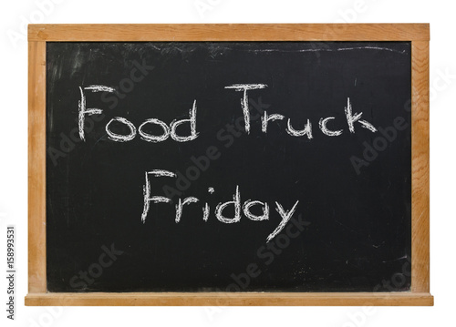 Food Truck Friday written in white chalk on a black chalkboard isolated on white