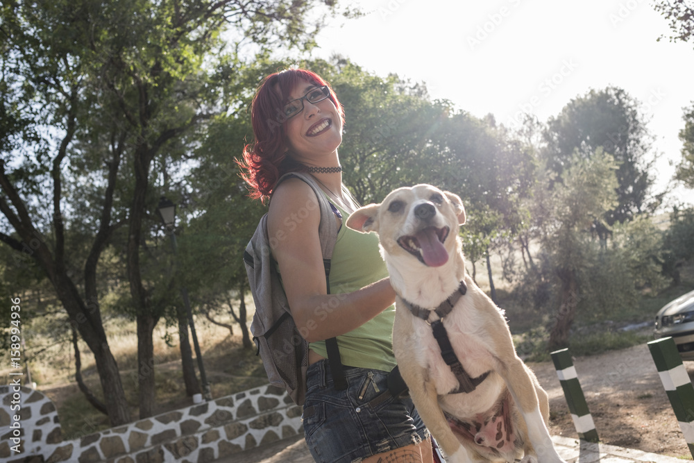 Woman with dog in outdoors image, she love his pet. Dog on bike in city park. Woman with dog in outdoors image, she love his pet. Dog on bike in city park.