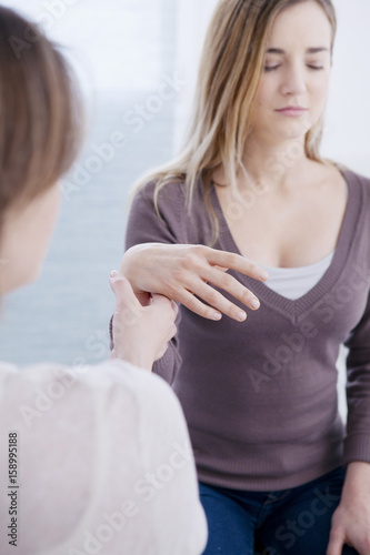 Woman undergoing hypnosis session photo