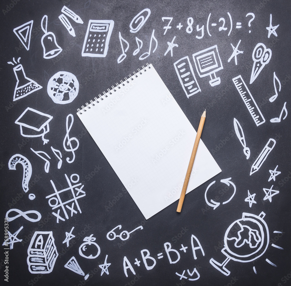 drawings on the chalkboard on the new academic year, fall, school supplies, drawn around a notebook with a pencil, place for text,frame drawings on the chalkboard on the new academic year, fall, school supplies, drawn around a notebook with a pencil, place for text,frame