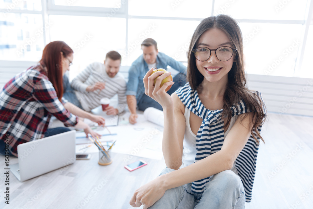 Delighted positive woman having an apple in her hands Delighted positive woman having an apple in her hands