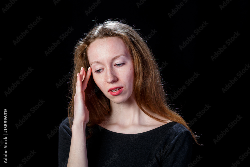 Young brown hair girl with headache on black background Young brown hair girl with headache on black background