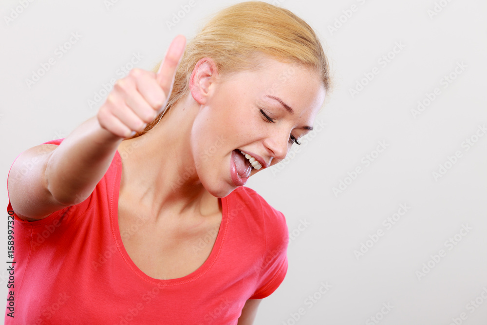 Happy woman showing thumbs up gesture Happy woman showing thumbs up gesture