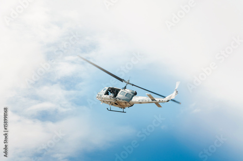 Fototapeta Naklejka Na Ścianę i Meble -  Helicopter in flight, blue sky background
