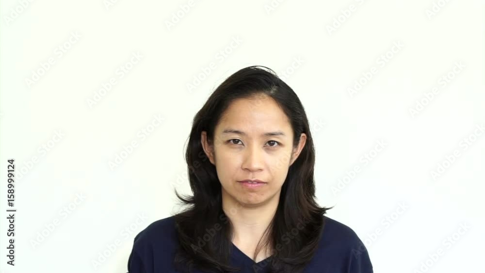 Casual adult Asian woman hiding her face behind summer hat. Abstract not showing her emotion Casual adult Asian woman hiding her face behind summer hat. Abstract not showing her emotion