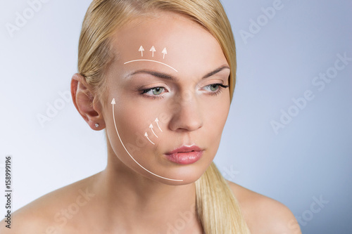 Young beautiful woman with surgical markers on face