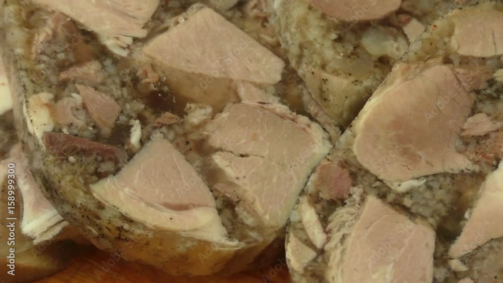 Pork meat jelly aspic galantine on a wooden board
Pork meat jelly aspic galantine on a wooden board