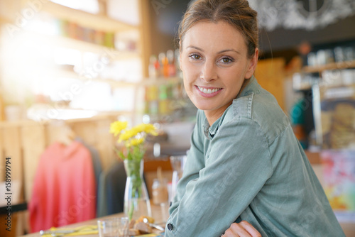 Portrait of young woman, sitting in coffee shop