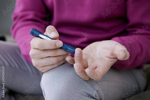 Man checking his blood glucose level
