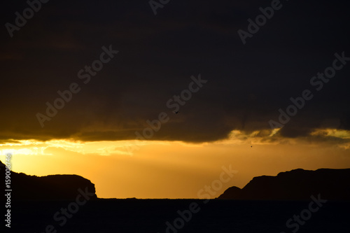  Sunrise over headland and the Atlantic Ocean from the beach at Porto Santo Island, Madeira, Portugal