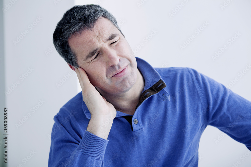 Man suffering from earache Man suffering from earache