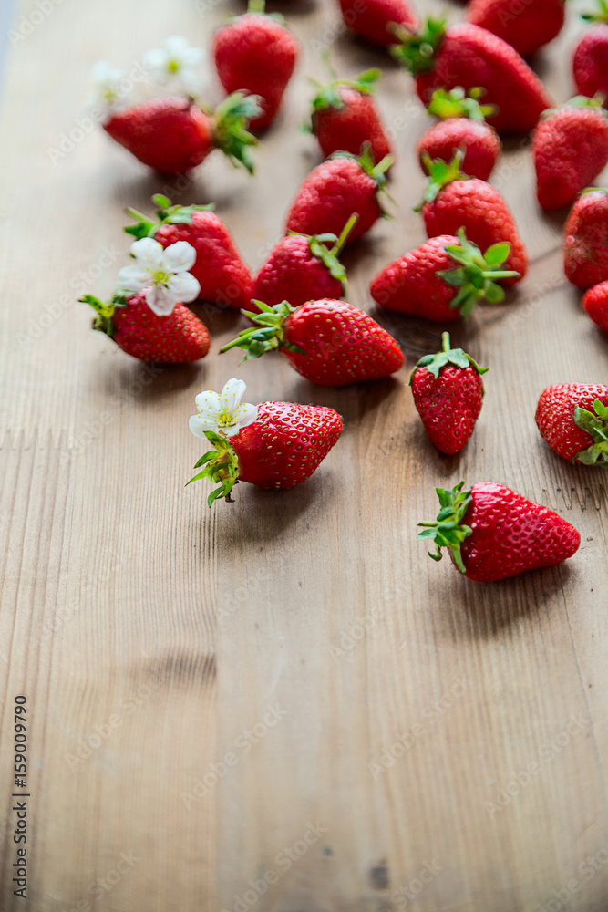 Fresh and ripe strawberries on a wooden background Summer food concept Copy space Top view