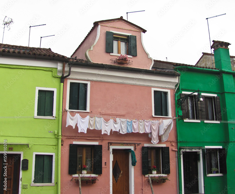 Fototapeta premium Burano, near Venice, Italy. Bright colored houses and laundry hung up to dry