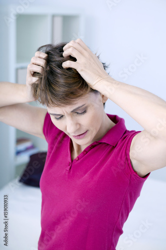 Woman scratching her head