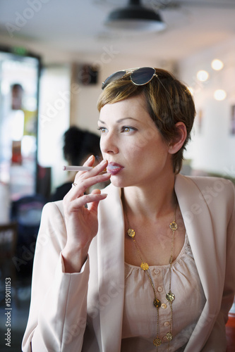 Woman with an electronic cigarette in a public place