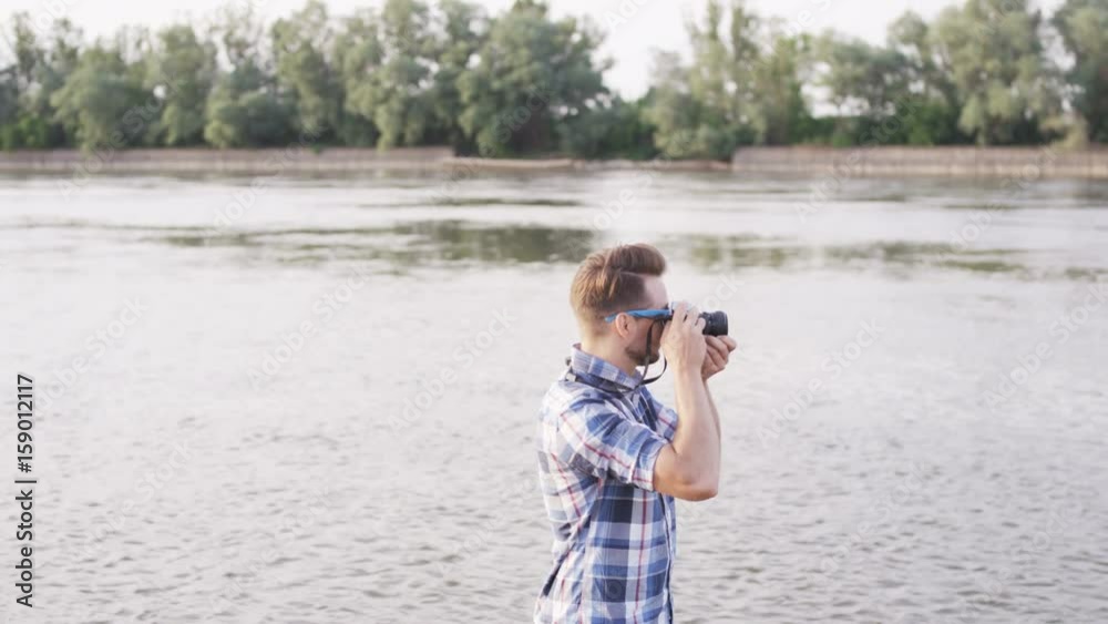 Young Man Standing and Taking Pictures in the Wild Young Man Standing and Taking Pictures in the Wild
